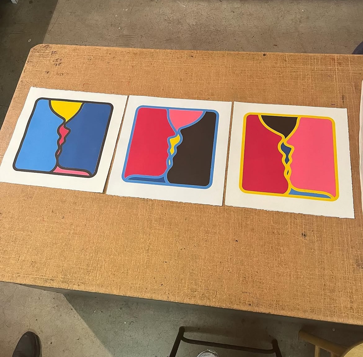 Three bold graphic prints on a studio table
