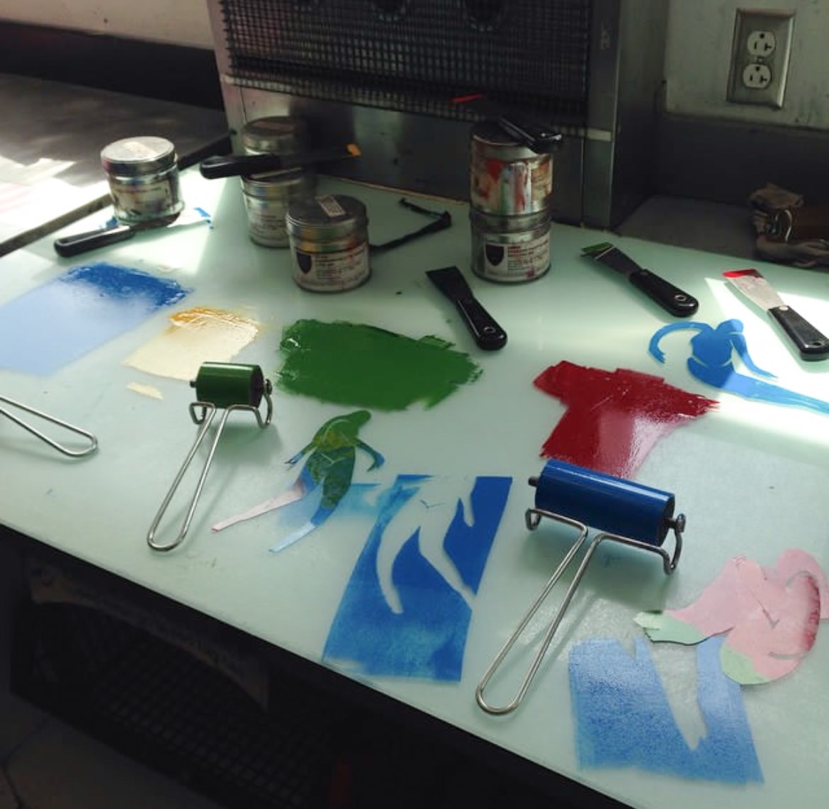 Ink rollers and paint swatches on printmaking studio table