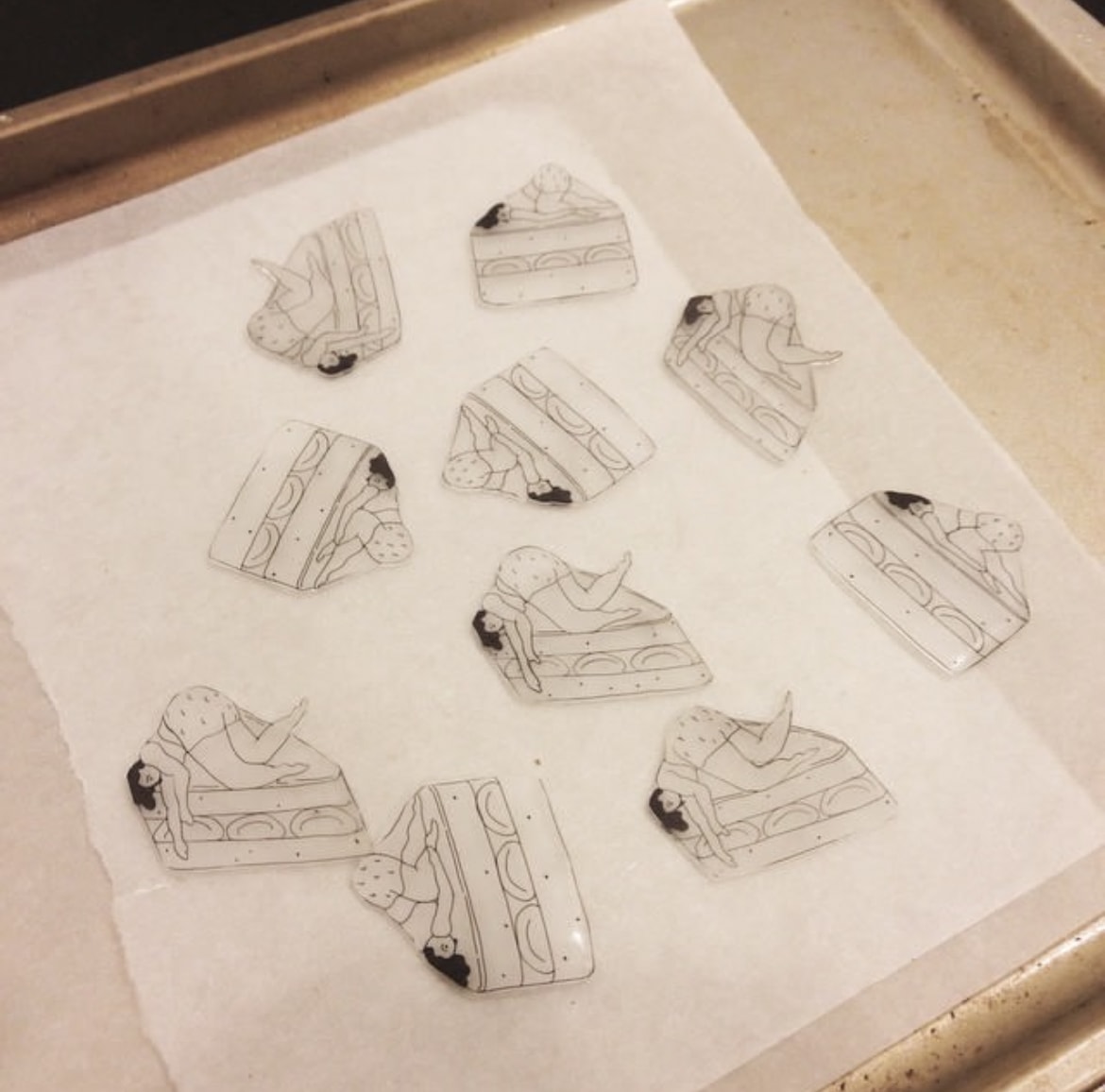 Cake slice pin sketches on parchment paper baking tray