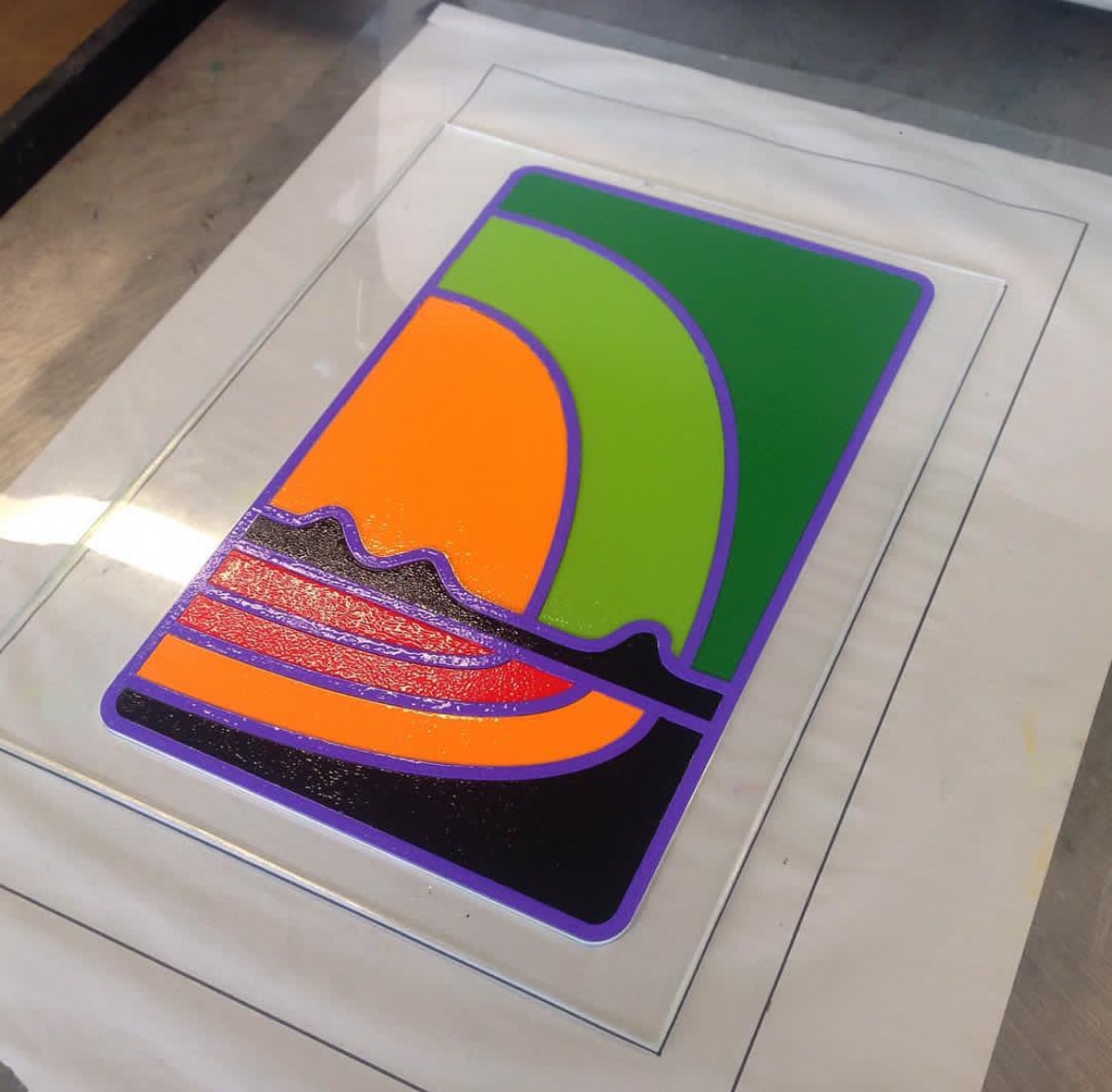 Colorful abstract print with orange green and purple on glass plate