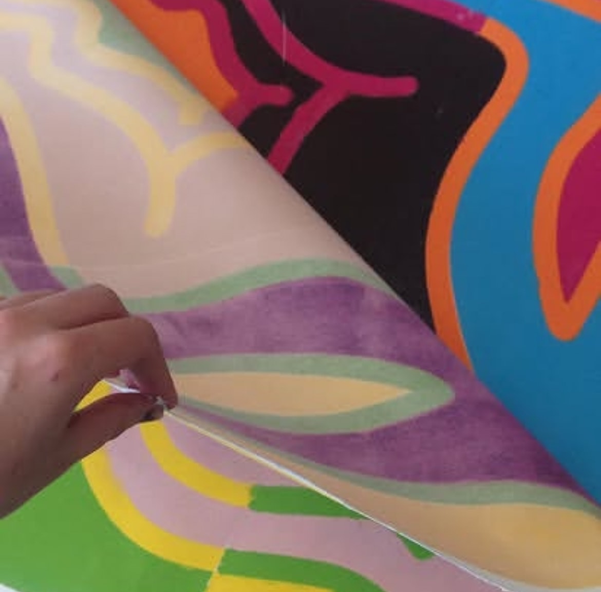 Peeling back a colorful large-scale print