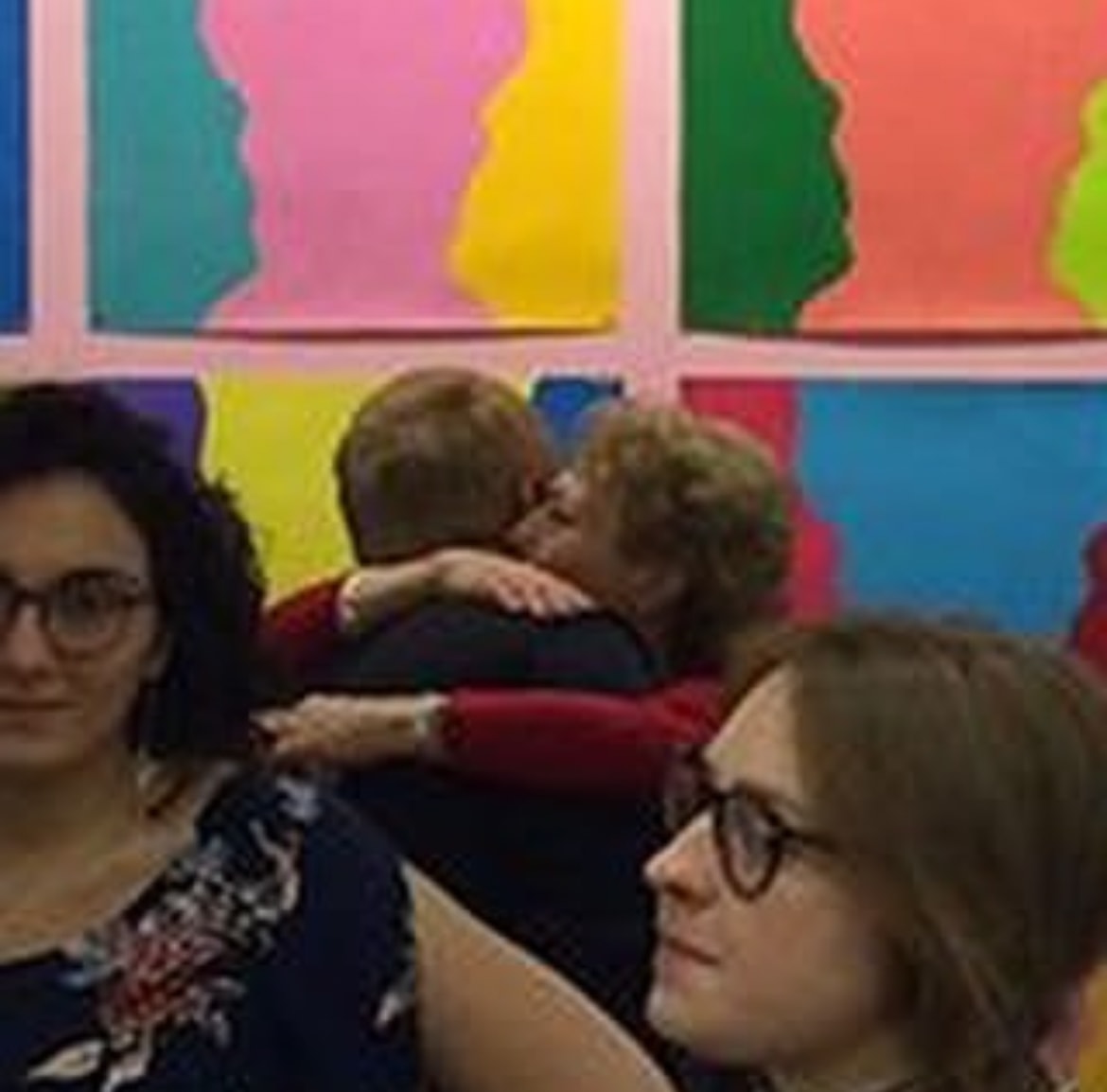 Gallery opening with colorful prints on the wall